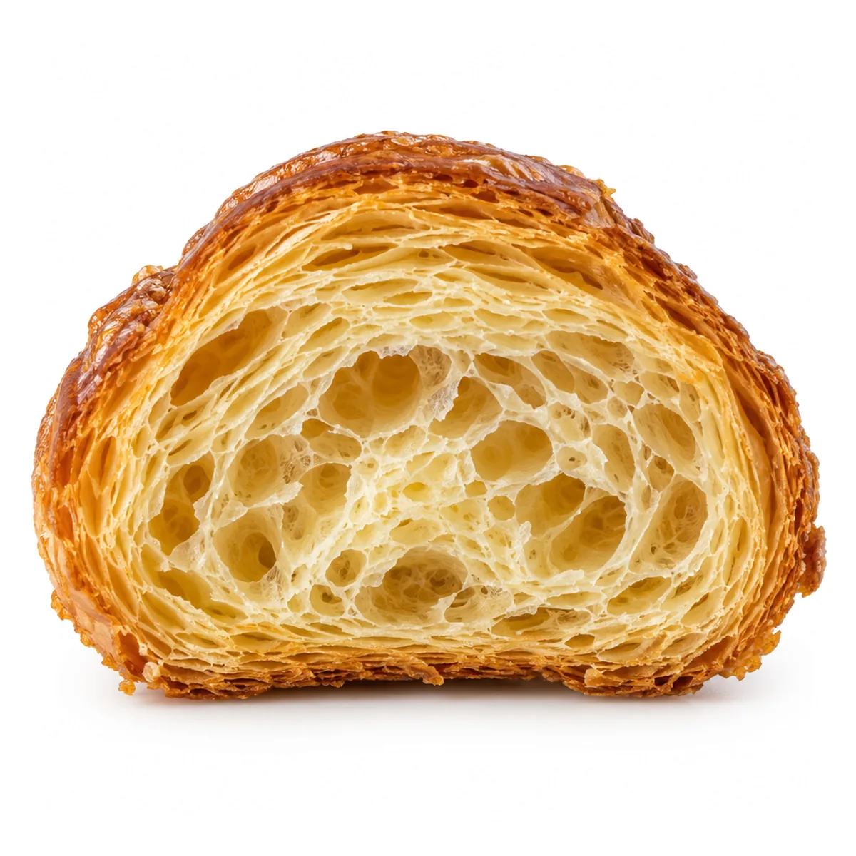 A croissant cut in half showing its open honeycomb of layers
