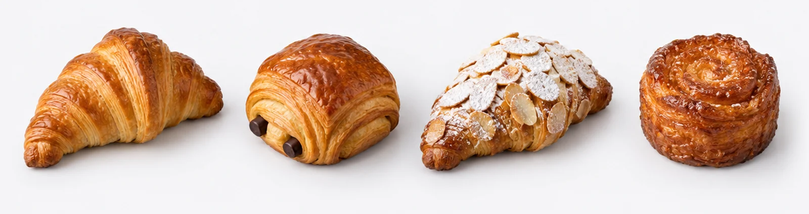 Butter croissant, pain au chocolat, almond croissant and kouign-amann in a row
